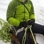 Todd belaying from the chains at the belay boulder